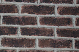 Close-up of a brick wall with dark red bricks